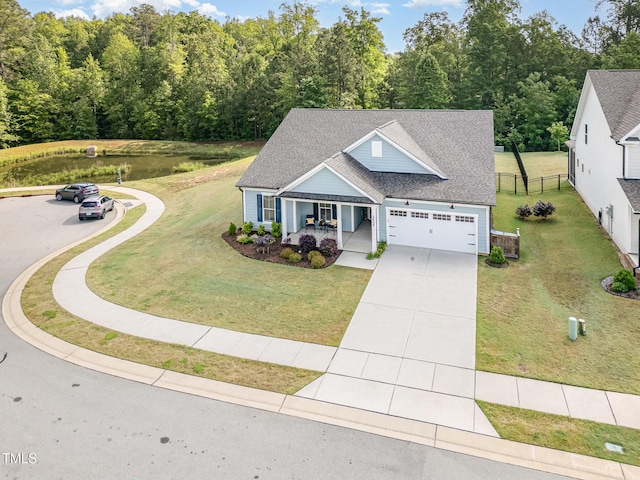 view of front of home featuring covered porch, roof with shingles, driveway, and an attached garage