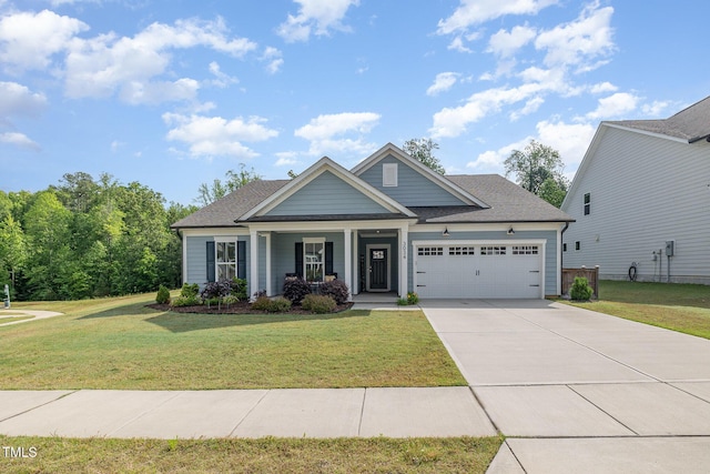 craftsman-style house featuring an attached garage, covered porch, a front lawn, and concrete driveway