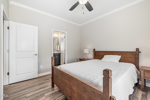 bedroom featuring crown molding, wood finished floors, baseboards, a ceiling fan, and connected bathroom
