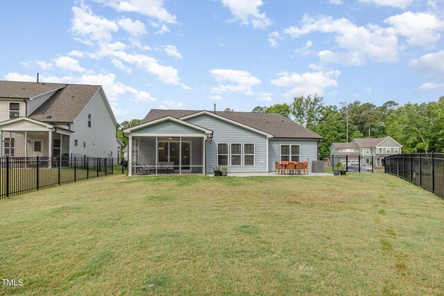 back of property with a sunroom, a ceiling fan, and a patio area