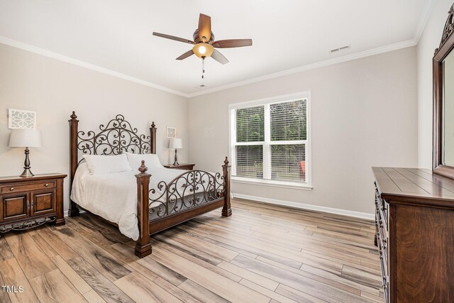 bedroom with crown molding, light wood finished floors, baseboards, and ceiling fan