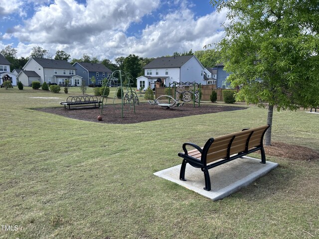 view of home's community with a residential view and a lawn