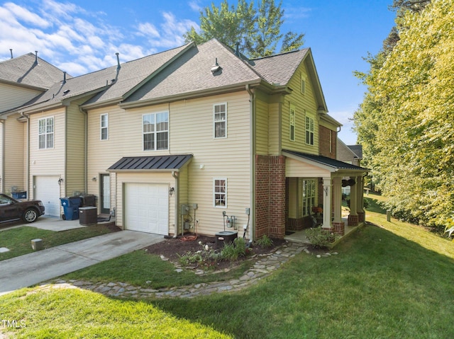 exterior space featuring an attached garage, roof with shingles, a yard, and concrete driveway