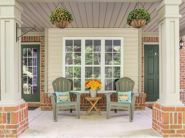 exterior space with brick siding and covered porch