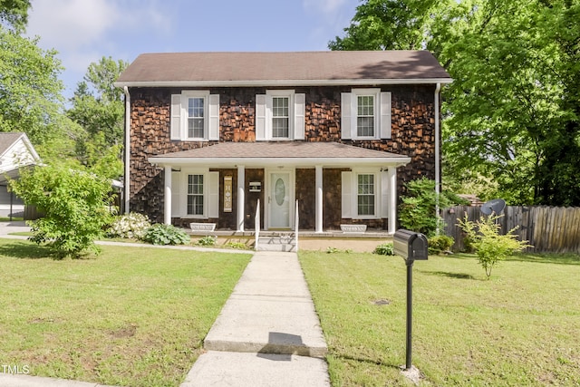 view of front of property with a porch, stone siding, and a shingled roof