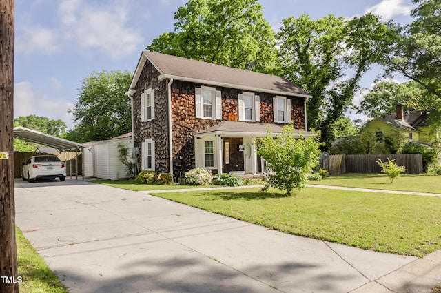 view of front of property with driveway, stone siding, and a detached carport