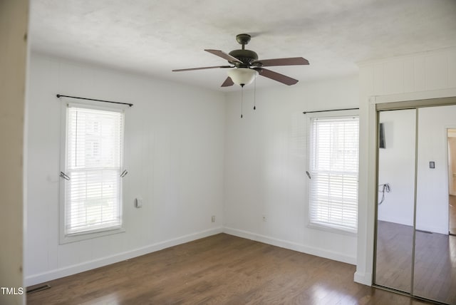 unfurnished bedroom with wood finished floors, baseboards, ceiling fan, and crown molding