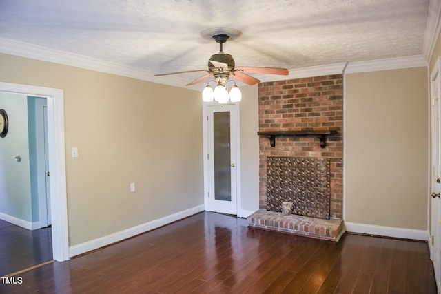 unfurnished living room with a ceiling fan, baseboards, wood finished floors, ornamental molding, and a brick fireplace