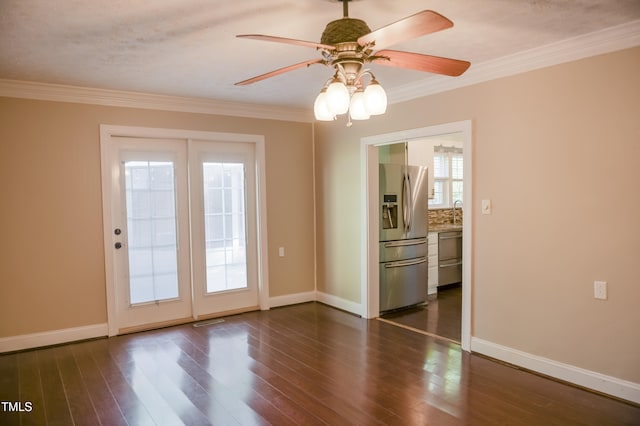 unfurnished room featuring ornamental molding, dark wood-style floors, baseboards, and ceiling fan