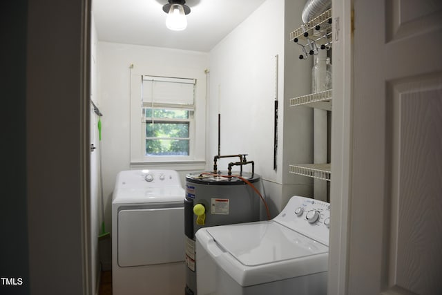 laundry room with washer and dryer and electric water heater