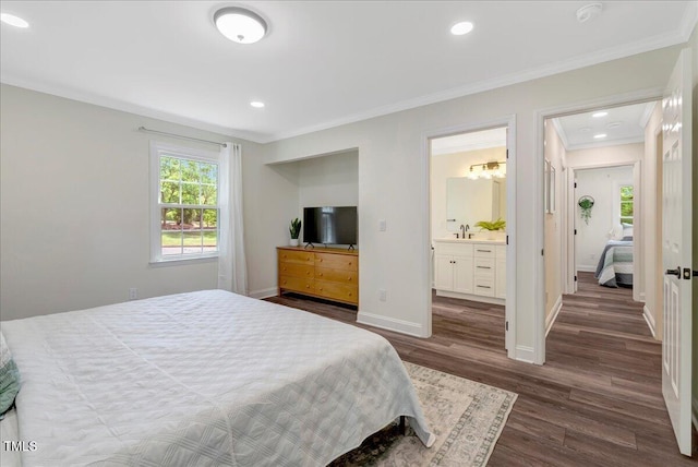 bedroom featuring a sink, ornamental molding, recessed lighting, baseboards, and dark wood-style floors