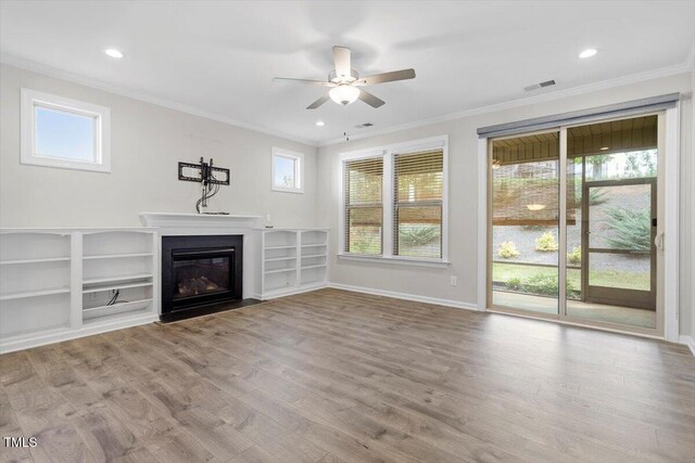52 Brunello Ct, Clayton, NC 27527 - unfurnished living room with a ceiling fan, a fireplace with flush hearth, ornamental molding, and plenty of natural light