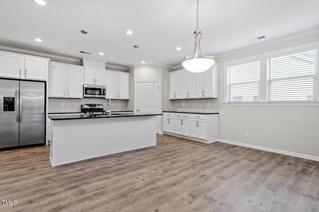 52 Brunello Ct, Clayton, NC 27527 - kitchen with visible vents, ornamental molding, decorative backsplash, dark countertops, and stainless steel appliances