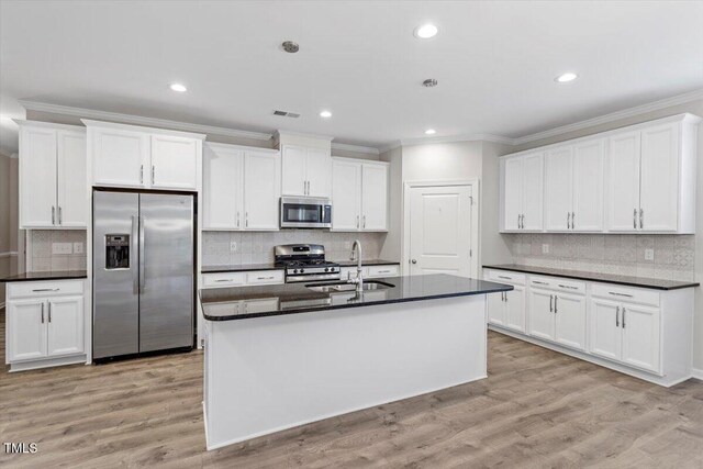 52 Brunello Ct, Clayton, NC 27527 - kitchen with backsplash, dark countertops, appliances with stainless steel finishes, and a sink