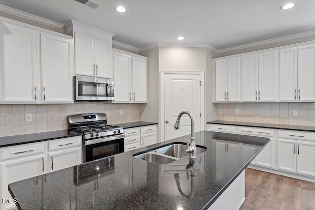 52 Brunello Ct, Clayton, NC 27527 - kitchen with a sink, white cabinets, stainless steel appliances, and visible vents