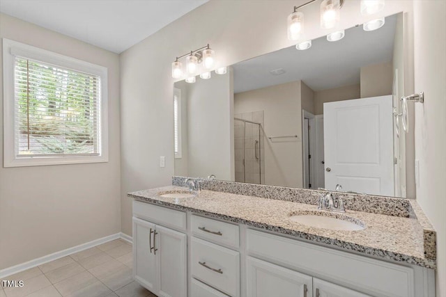 52 Brunello Ct, Clayton, NC 27527 - bathroom with double vanity, baseboards, a shower stall, and a sink