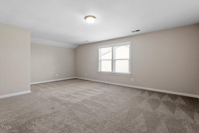 52 Brunello Ct, Clayton, NC 27527 - carpeted empty room featuring baseboards, visible vents, and vaulted ceiling