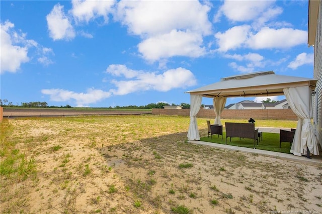 view of yard featuring fence, a patio, and a gazebo