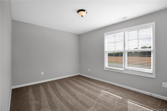 unfurnished room featuring baseboards, carpet flooring, and visible vents