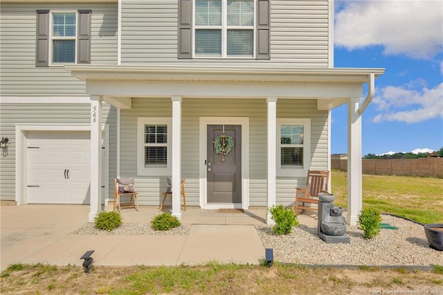 566 Carolina Church Rd, Saint Pauls, NC 28384 - doorway to property featuring a porch, a garage, and concrete driveway