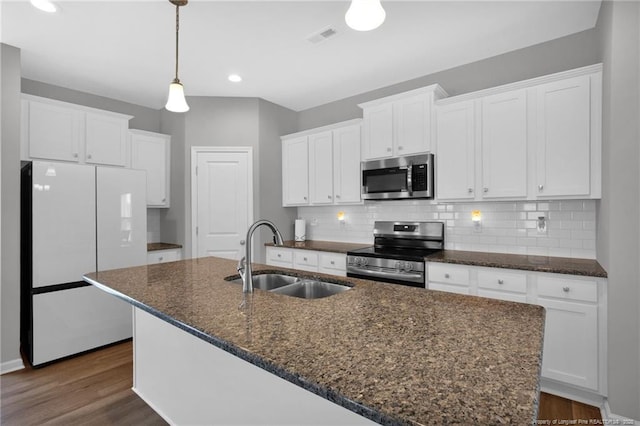 566 Carolina Church Rd, Saint Pauls, NC 28384 - kitchen with appliances with stainless steel finishes, a sink, white cabinets, a center island with sink, and recessed lighting
