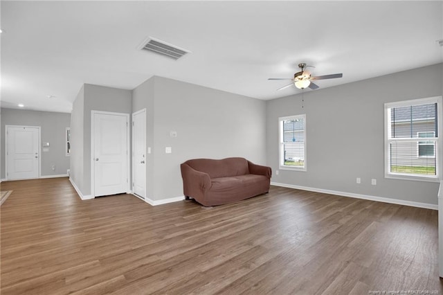 566 Carolina Church Rd, Saint Pauls, NC 28384 - living area with wood finished floors, baseboards, a ceiling fan, and recessed lighting