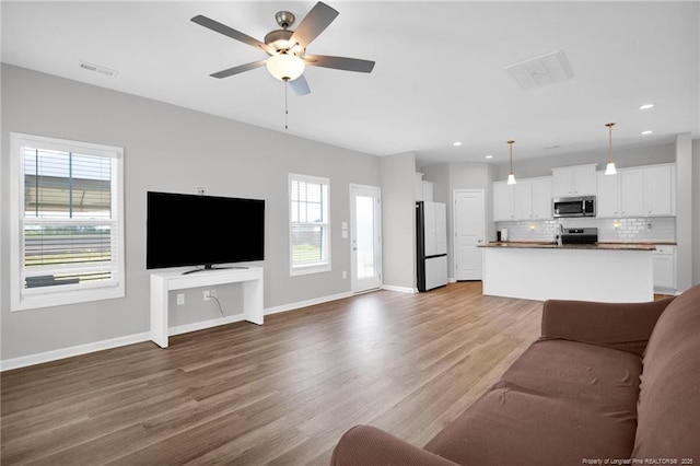 566 Carolina Church Rd, Saint Pauls, NC 28384 - living room with a ceiling fan, light wood finished floors, recessed lighting, and baseboards