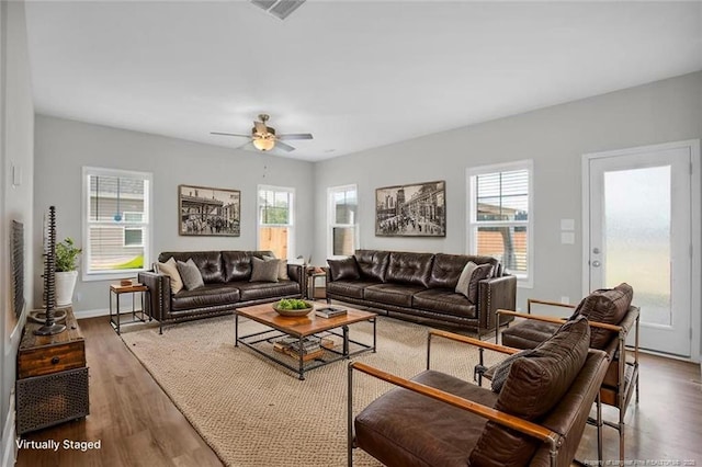 566 Carolina Church Rd, Saint Pauls, NC 28384 - living area with plenty of natural light, wood finished floors, a ceiling fan, and baseboards