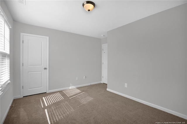 566 Carolina Church Rd, Saint Pauls, NC 28384 - carpeted empty room featuring baseboards