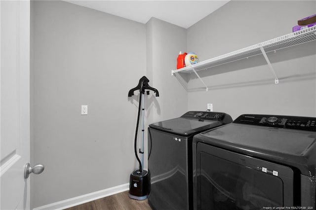 566 Carolina Church Rd, Saint Pauls, NC 28384 - laundry area featuring dark wood-style flooring, washing machine and dryer, and baseboards