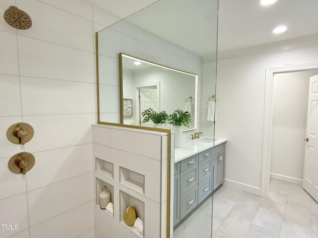 bathroom featuring vanity, tile patterned flooring, recessed lighting, and tiled shower