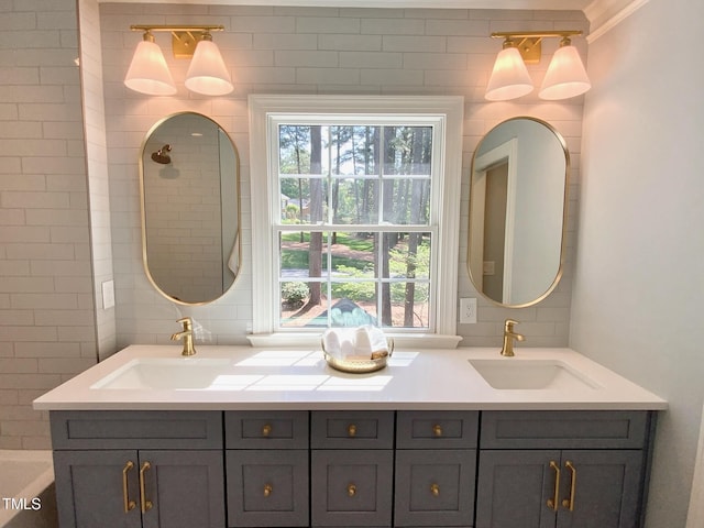 bathroom with double vanity, plenty of natural light, and a sink