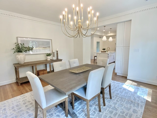 dining space featuring light wood-type flooring, baseboards, and a chandelier