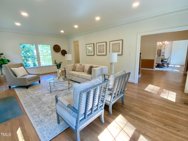 living area featuring recessed lighting, baseboards, a chandelier, and light wood-style floors