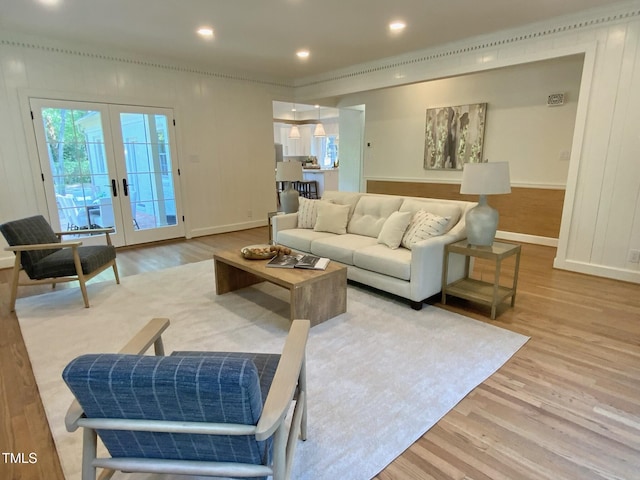 living room featuring french doors, recessed lighting, baseboards, and wood finished floors