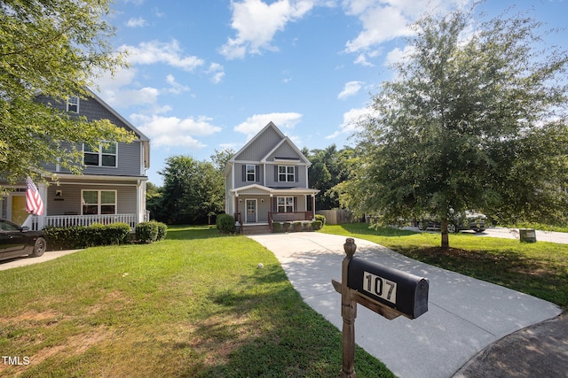 107 Cottage Ct, Youngsville, NC 27596 - view of front of property with covered porch, a front yard, and driveway