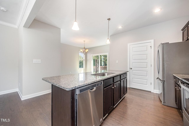 107 Cottage Ct, Youngsville, NC 27596 - kitchen featuring appliances with stainless steel finishes, dark wood-type flooring, a chandelier, an island with sink, and light stone counters