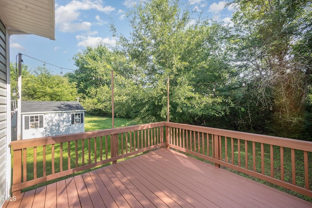 107 Cottage Ct, Youngsville, NC 27596 - wooden terrace with a lawn and an outdoor structure