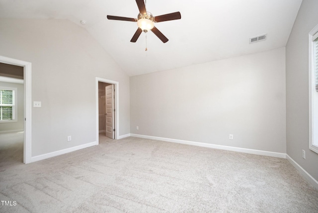 107 Cottage Ct, Youngsville, NC 27596 - unfurnished bedroom featuring light carpet, lofted ceiling, a walk in closet, and a ceiling fan