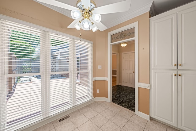 unfurnished dining area with crown molding, ceiling fan, light tile patterned flooring, and visible vents