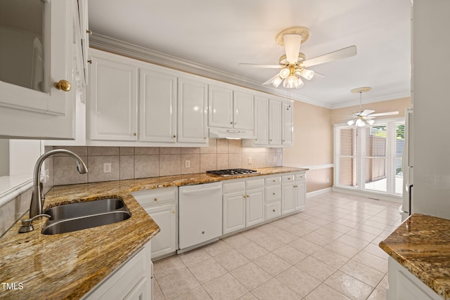 kitchen featuring backsplash, white dishwasher, white cabinets, and a sink