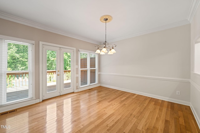 unfurnished dining area featuring an inviting chandelier, french doors, light wood-type flooring, and a wealth of natural light