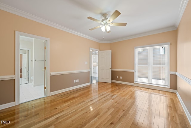 interior space featuring baseboards, ensuite bath, ornamental molding, and light wood-style floors