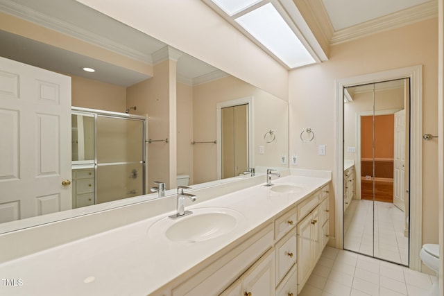 full bath with crown molding, toilet, and a sink