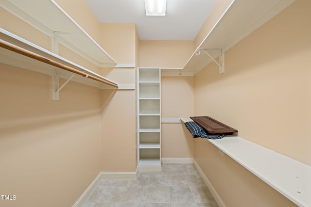 walk in closet featuring light tile patterned flooring