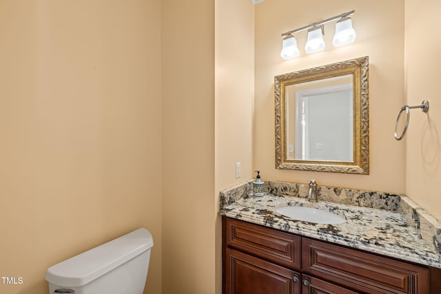 half bath with vanity and toilet