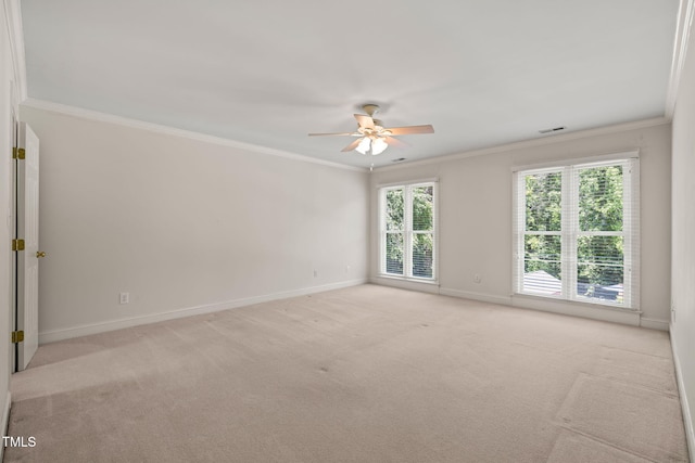 unfurnished room featuring crown molding, baseboards, light carpet, and a ceiling fan