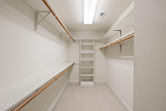 spacious closet featuring light colored carpet and visible vents