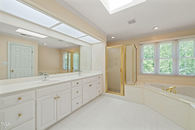bathroom featuring visible vents, ornamental molding, a sink, and a garden tub