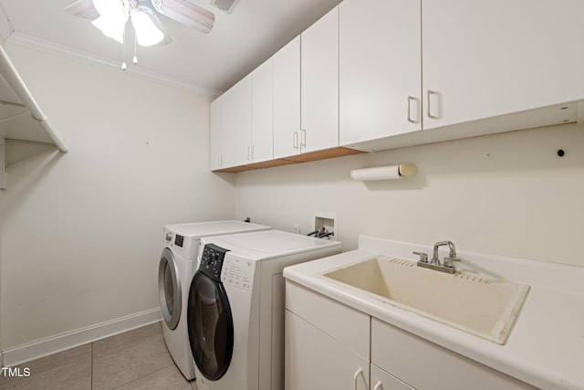 washroom with washing machine and dryer, baseboards, ceiling fan, a sink, and cabinet space